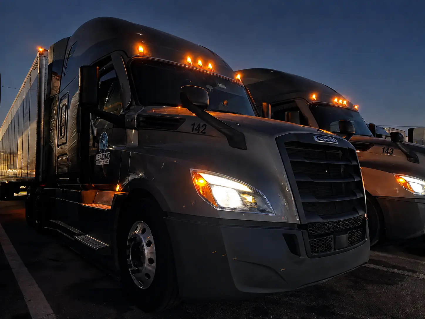 Leading Logistics Inc. trucks ready for the road at dusk